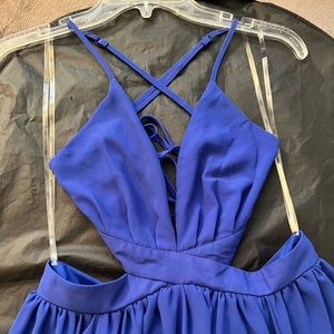 Brand new w/ tags. Long maxi royal blue dress w/ side cut outs,cross cross back